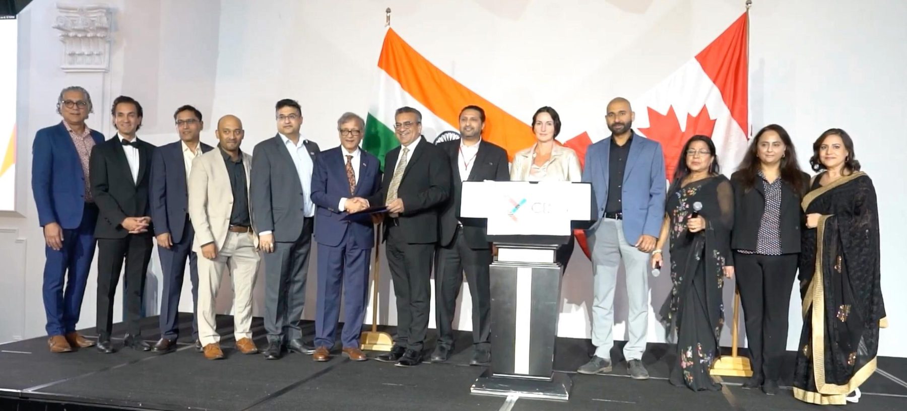 TiE Vancouver leaders on stage at a partnership signing