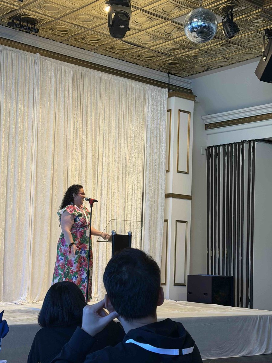 A founder presenting on stage during the 2026 program